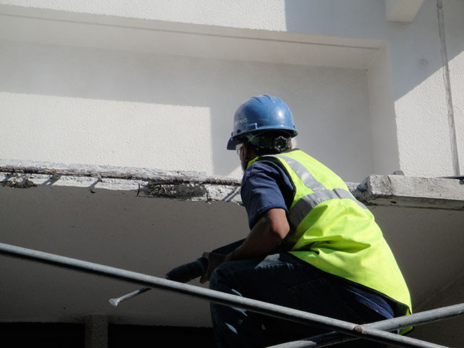 Worker Repairing Ceiling