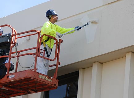 Painter on Lift With Roller